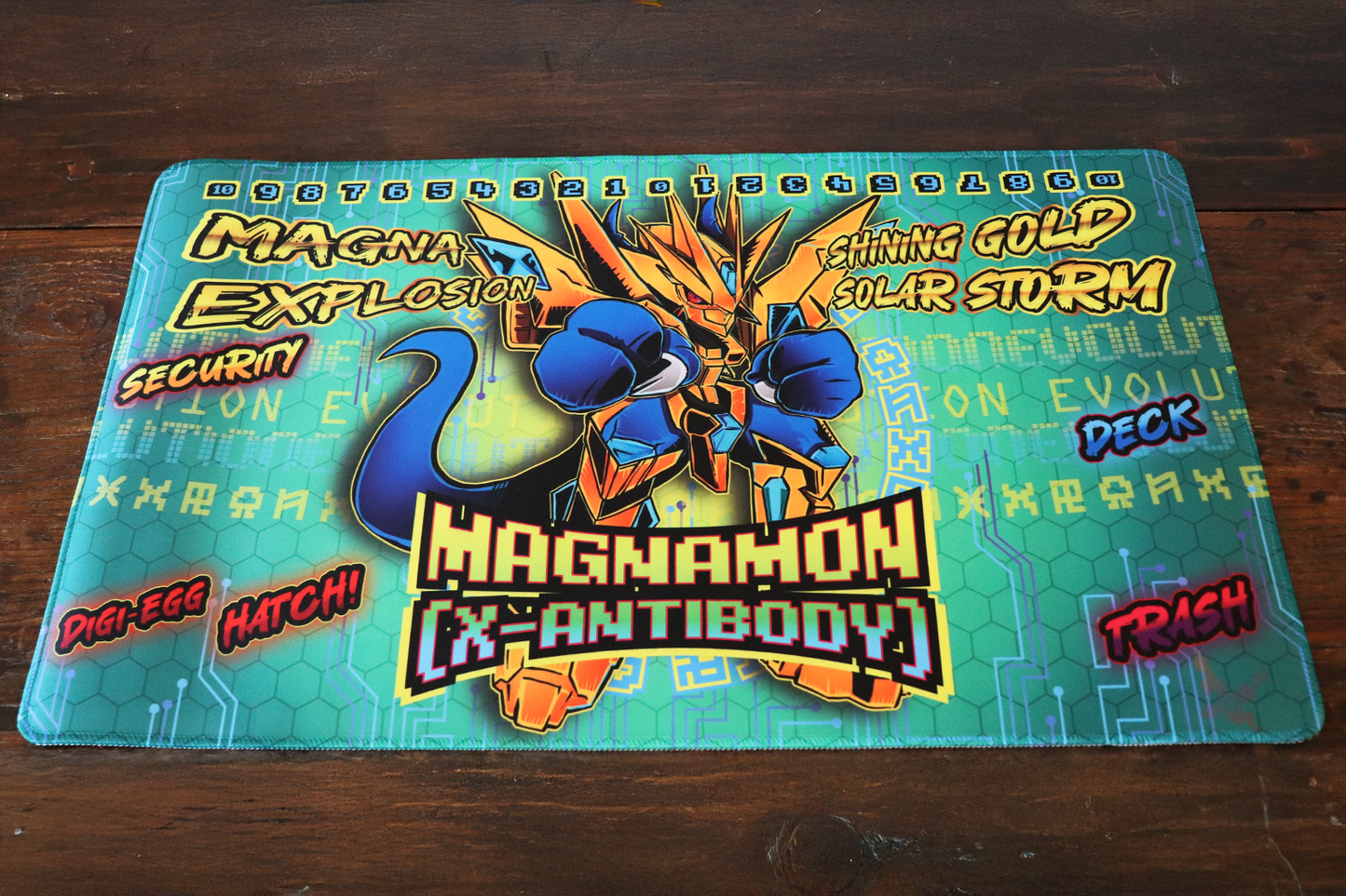 Digimon Card Game playmat artwork featuring Magnamon X-Antibody in gold armor with bold comic-style text callouts, a teal cyber grid and hex pattern background, and a memory gauge counter across the top.