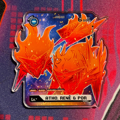 Photo of the Atho, René & Por Digimon acrylic Digimon token on a playmat, orange flame spirit design for a Jesmon Digimon playmat, Digimon TCG token accessory for the Digimon card game.