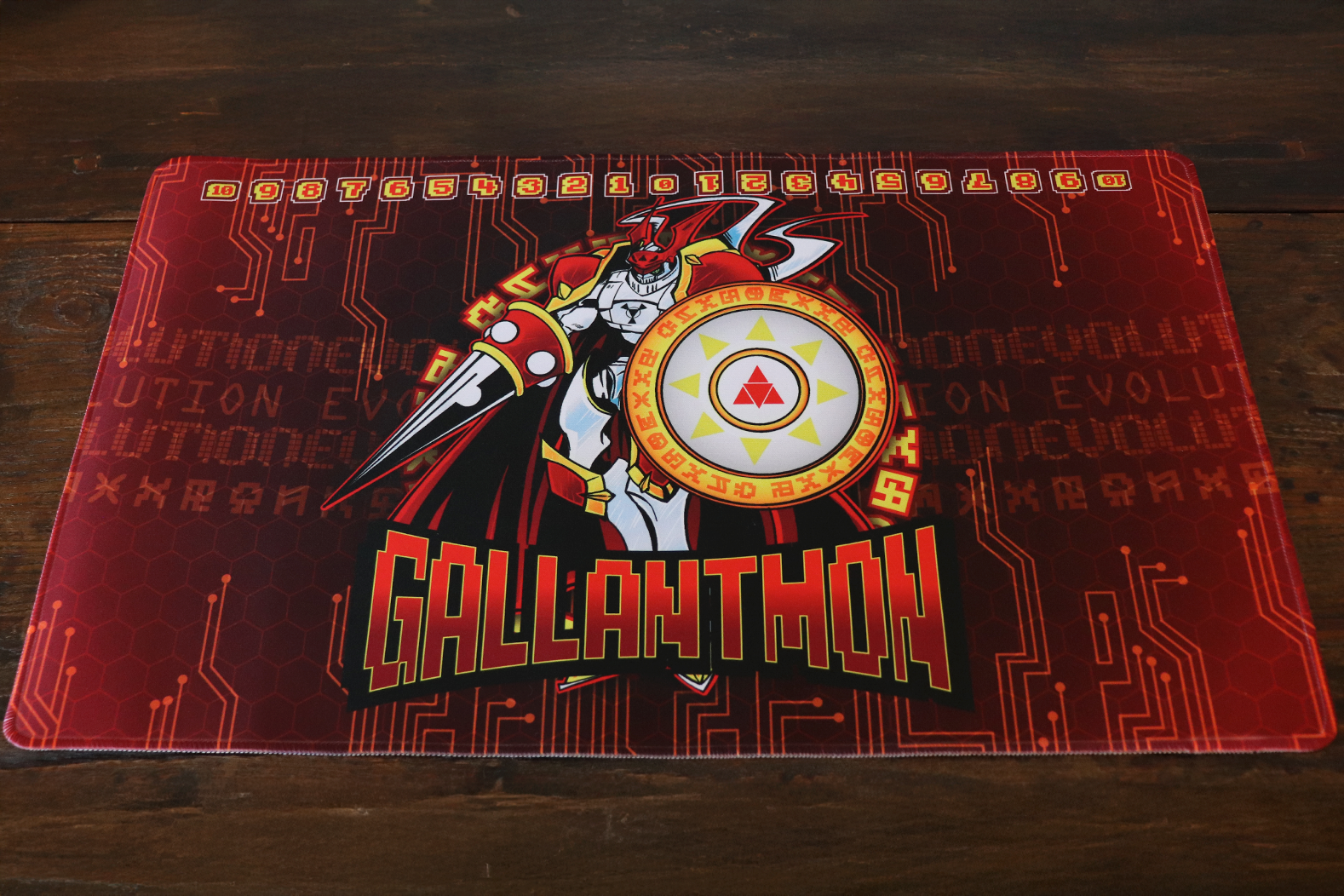 Digimon Card Game playmat artwork featuring Gallantmon (Dukemon) as a crimson knight with lance and shield, set on a red cyber circuit and hex pattern background with a memory gauge counter across the top.