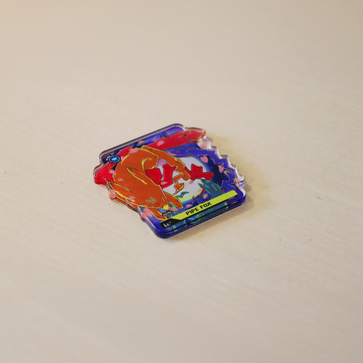 Pipe Fox acrylic token for a Sakuyamon Digimon TCG playmat, clear glossy acrylic accessory with Pipe Fox artwork on a tabletop product photo.